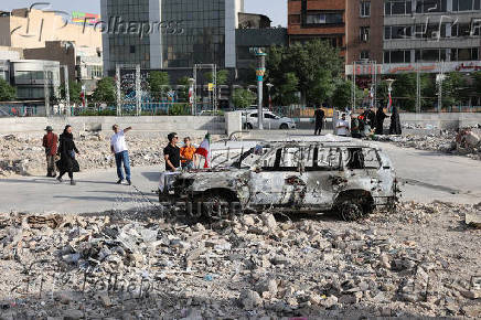 An ambulance burned by Israeli attacks stands on a street in Tehran