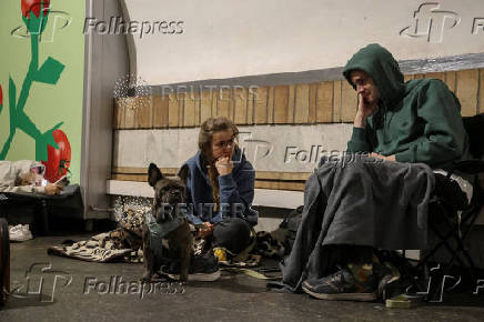 People take shelter inside a metro station during a Russian drone and missile strike in Kyiv