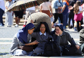 Pope Leo XIV leads the Regina Caeli prayer from his window in St. Peter's Square, at the Vatican