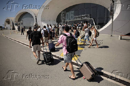 People board Crown Iris, a cruise ship which will be used to assist in the departure of Israelis from Cyprus, at the port in Limassol