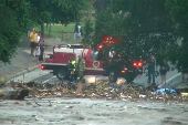 First responders survey rising flood waters of the Guadalupe River after flash flooding in Kerr County