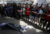 Mourners pray during the funeral of Palestinians killed in overnight Israeli strikes, according to medics, at Al-Shifa hospital in Gaza City