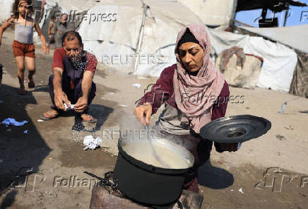 Displaced Palestinians who have not received humanitarian aid survive on leftover food, in Gaza