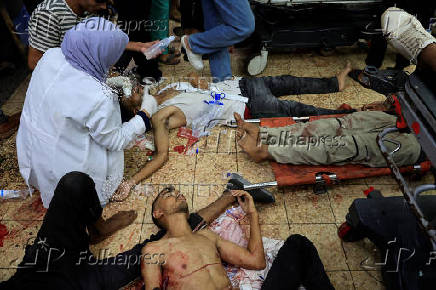 Palestinian casualties of Israeli fire, who were seeking aid, according to medics, are assisted at Nasser Hospital in Khan Younis, southern Gaza Strip