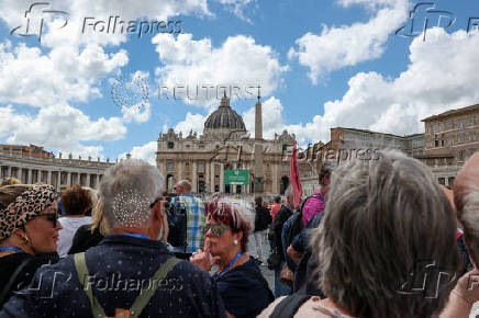 Tourists stand near Saint Peter?s Basilica ahead of the conclave