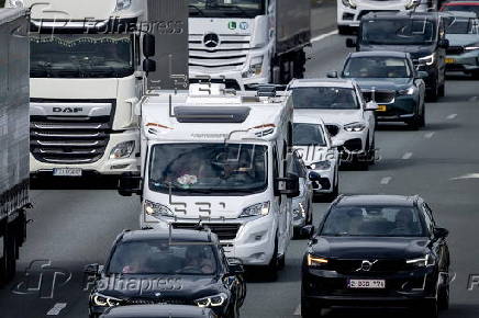 Vacationers have their vehicles checked at the border crossing with Belgium