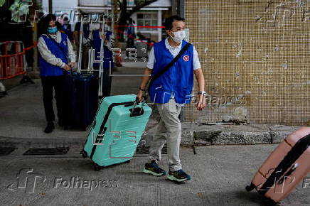 Hong Kong residents affected by the fire gather their belongings from their apartments
