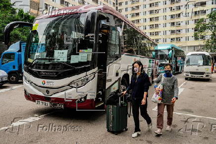 Hong Kong residents affected by the fire gather their belongings from their apartments