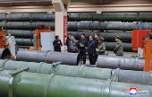 North Korea's leader Kim Jong Un visits a factory that makes shells and machinery