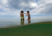 Boys enjoy Sao Conrado beach during the World Oceans Day, at Sao Conrado beach in Rio de Janeiro