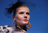 A model prepares to take part in a fashion competition during the Durban July horse race in Durban
