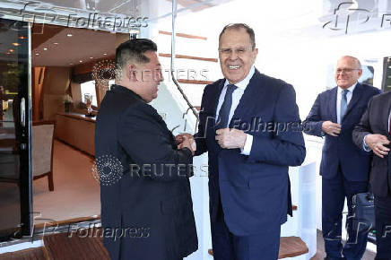 North Korean leader Kim Jong Un shakes hands with Russian Foreign Minister Sergei Lavrov during a meeting in Wonsan