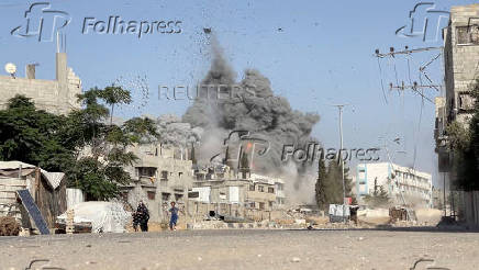 A girl runs from the scene after Israeli strikes on a school sheltering displaced people at the Bureij refugee camp in the central Gaza Strip