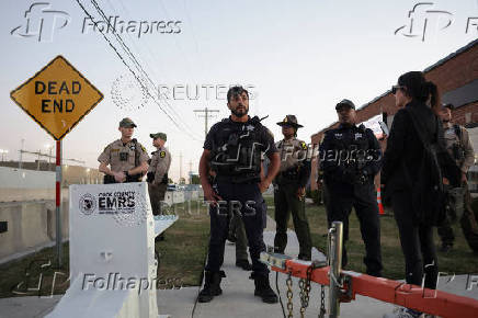 Law enforcement officers stand guard after curfew near the U.S. Customs and Immigration Enforcement facility, in Broadview