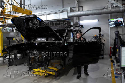 Technicians work on the assembly line for Rolls-Royce Cullinan vehicles at Rolls-Royce Motor Cars' manufacturing plant in Goodwood