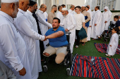 Palestinians from Gaza attend Eid al-Adha prayers, at Al Thumama Complex,  in Doha
