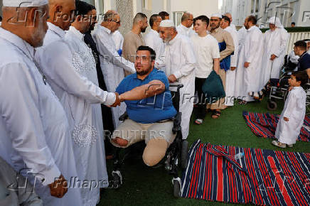 Palestinians from Gaza attend Eid al-Adha prayers, at Al Thumama Complex, in Doha