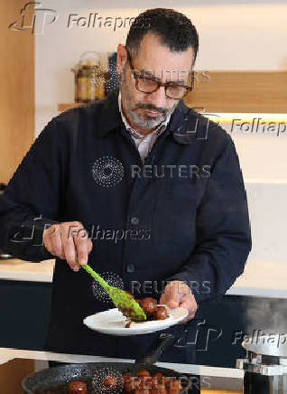 Palestinian-British chef Tamimi prepares food during  interview with Reuters at his home in London