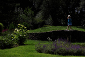 A girl walks in a garden of flowers, in Lullymore