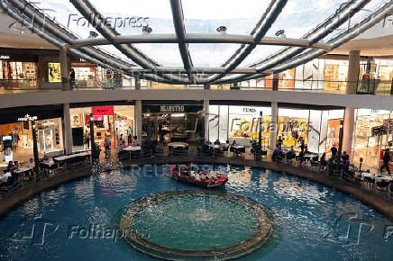 People take a sampan ride in the Marina Bay Sands mall in Singapore