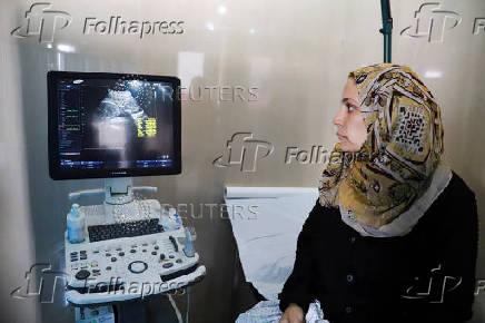 Fatima Arafa, a pregnant and displaced Palestinian woman, has a consultation with a doctor, at Al-Helou hospital, in Gaza City