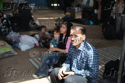 An Afghan family deported from Iran sits in a tent at a camp for returning migrants near the Islam Qala border crossing