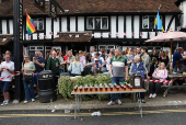 Beers are lined up at the Pinner Wheelbarrow Race as part of a St. George's Day celebration, in London