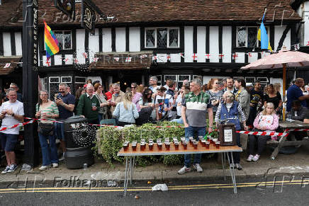 Beers are lined up at the Pinner Wheelbarrow Race as part of a St. George's Day celebration, in London