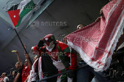 Jordanians celebrate a goal scored by their national football team against Oman as Jordan qualified for the World Cup for the first time after 3-0 win over Oman, in Amman