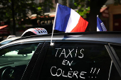 French taxi drivers protest near the Bercy Economy and Finance Ministry in Paris