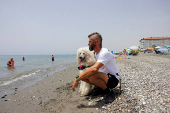 Nilo, a Standard Poodle dog, uncommonly trained to save lives at Las Lindes beach as the latest member added to a dog rescue team, in Torrox