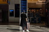 A person reads the Amtrak schedule in Moynihan Train Hall at Penn Station in New York