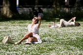 People enjoy the sunny weather in London