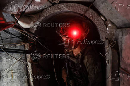 An Israeli soldier stands inside a tunnel underneath the European Hospital in Khan Younis at the Gaza Strip
