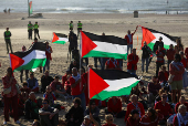 Pro-Palestinian protesters demonstrate on the Zuiderstrand beach against the violence in Gaza