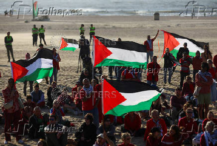 Pro-Palestinian protesters demonstrate on the Zuiderstrand beach against the violence in Gaza