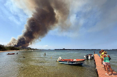 Wildfire burns in the village of Vourvourou