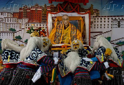 Tibetans mark the 90th birthday celebration of their spiritual leader, the Dalai Lama, at Jawalakhel Handicraft Center in Lalitpur