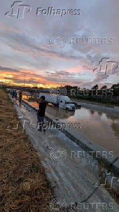 Vehicles stand on a flooded road, in Chattanooga