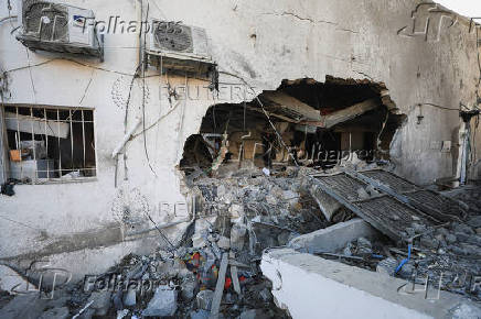 Palestinians inspect damage inside the Al-Ahli Arab Baptist Hospital in Gaza City