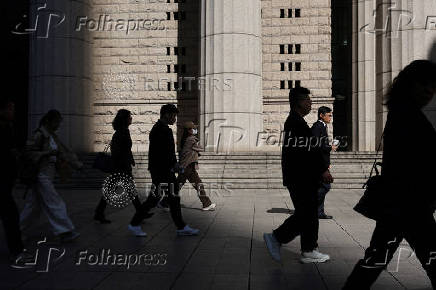 Commuters walk in Shanghai