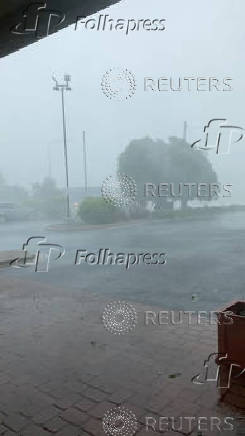 A tree sways amidst strong gusts of wind and rain, in Springfield, Missouri
