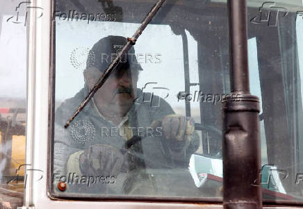 FILE PHOTO: Uruguay presidential candidate Mujica works on his farm after casting his vote during the Uruguayan National elections