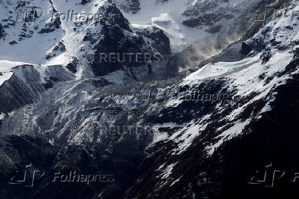 Debris and dust from a crumbling glacier that partially collapsed and tumbled onto the village of Blatten