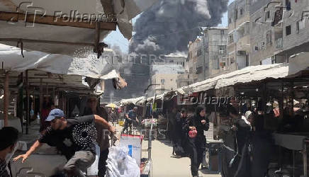 Smoke rises from a house hit by an Israeli strike in Gaza City