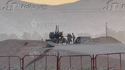 FILE PHOTO: Military personnel stand guard at Iran's Isfahan nuclear facility