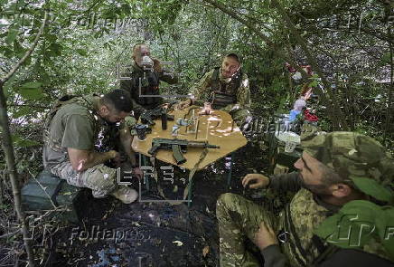 Ukrainian servicemen hold a position in the Kharkiv region