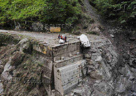A drone view of BRO and SDRF officials attempting to build a makeshift bridge in Gangnani