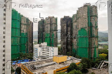 Hong Kong residents affected by the fire gather their belongings from their apartments