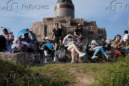People wait to watch SpaceX's next-generation Starship spacecraft atop its Super Heavy booster launch